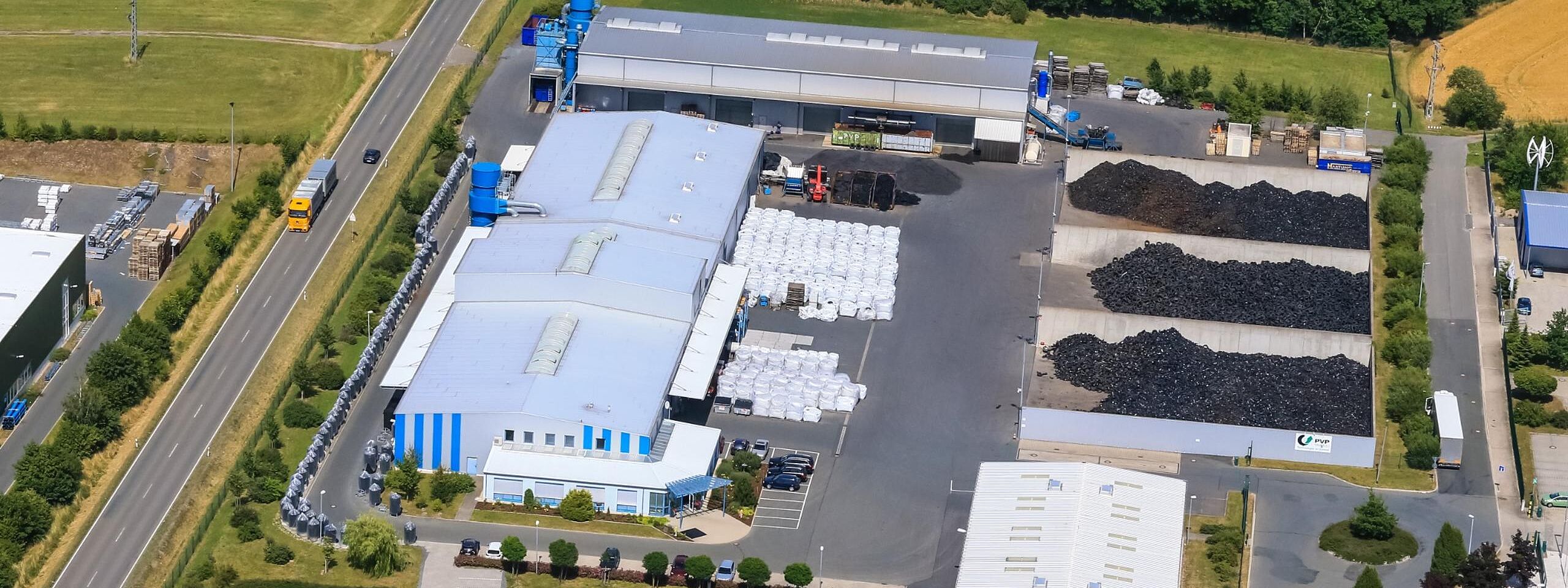 PVP Triptis GmbH in Thuringia, Germany | Tire Recycling Production Facility | Sustainable Rubber Processing Plant Aerial view of the PVP Triptis facility in Thuringia, Germany, showcasing the office building and advanced tire recycling production plant.
